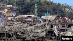 FILE - Damaged buildings are seen inside a war-torn area in Marawi City, southern Philippines, Oct. 24, 2017, after the Philippines announced on Monday the end of five months of military operations in a southern city held by pro-Islamic State rebels. 