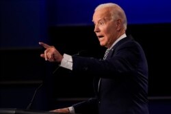 FILE - Democratic presidential candidate Joe Biden gestures while speaking during the first presidential debate, Sept. 29, 2020, at Case Western Reserve University and Cleveland Clinic, in Cleveland, Ohio.