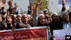 FILE - Pakistani students of Islamic seminaries chant slogans during a rally in support of blasphemy laws, in Islamabad, Pakistan, March 8, 2017.