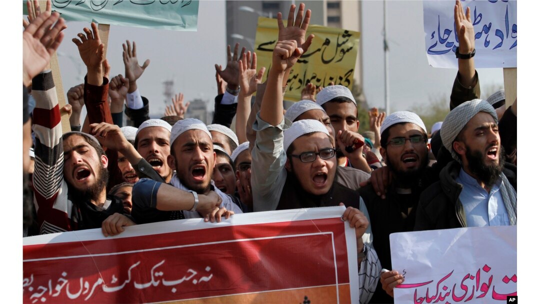 FILE - Pakistani students of Islamic seminaries chant slogans during a rally in support of blasphemy laws, in Islamabad, Pakistan, March 8, 2017.