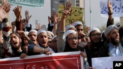 FILE - Pakistani students of Islamic seminaries chant slogans during a rally in support of blasphemy laws, in Islamabad, Pakistan, March 8, 2017.