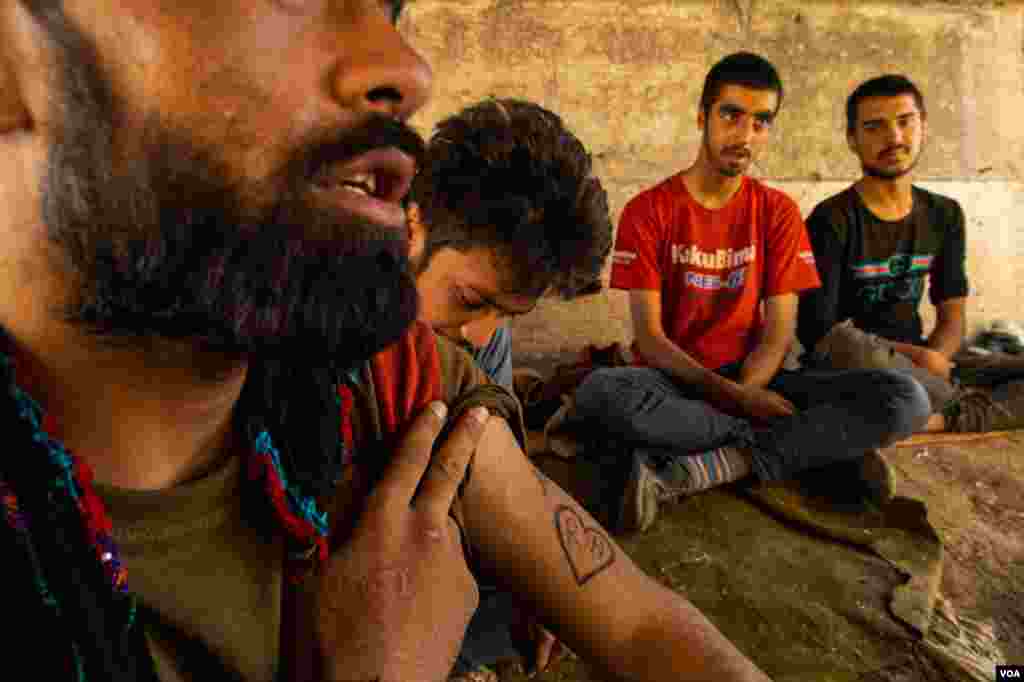 This man shows a tattoo of his fiancee&#39;s initials, saying he hopes to one day go back to Afghanistan to collect her, Aug. 31, 2021, in eastern Turkey. 