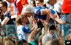 Iceland's Ari Skulason celebrates with a woman after a draw 1-1 in the group D match between Argentina and Iceland at the 2018 soccer World Cup in the Spartak Stadium in Moscow, Russia, June 16, 2018.