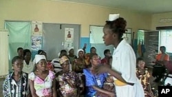 FILE -- A nurse-midwife speaks to pregnant women. A study published in The Lancet found more than one-third of new mothers in four poor countries are abused during childbirth.