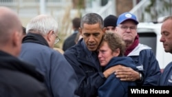 President Barack Obama hugs Donna Vanzant, the owner of North Point Marina, as he tours damage from Hurricane Sandy in Brigantine, N.J., Oct. 31, 2012. (White House/Pete Souza)