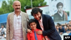 Turkish director Kaan Mujdeci (R), actor Dogan Izci (C) and actor Muttalip Mujdeci arrive for the screening of the movie "Sivas" presented in competition at the 71st Venice Film Festival on Sept. 3, 2014 at Venice Lido. 