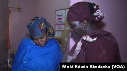 Aissa Doumara Ngatansou, right, talks with a young woman asking for help in Maroua, far north Cameroon, March 6, 2019.