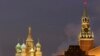 FILE - People walk in Red Square, with St. Basil Cathedral (left) the Kremlin's Spassky Tower (right rear) and Lenin Mausoleum (right) in Moscow, Dec. 10, 2009.