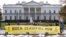 FILE — A large banner that says "Biden: Ceasefire Now," representing those killed in the escalating conflict in Gaza and Israel, is displayed in front of the White House, November 15, 2023, in Washington. 