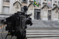A TV camera sits in front of Adolfo Lutz Institute, which is responsible for double checking the coronavirus test results, in Sao Paulo, Brazil, Feb. 26, 2020.