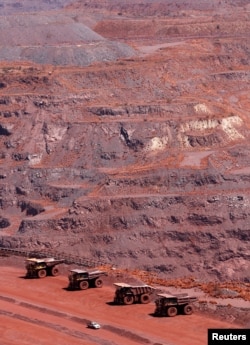 FILE— Haul trucks are seen at Kumba Iron Ore in Khathu, Northern Cape province in South Africa, November 15, 2011.