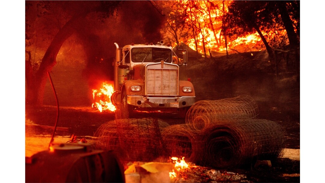 Flames from the Glass Fire burn a truck in a Calistoga, Calif., vineyard Oct. 1, 2020.