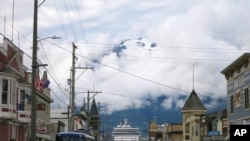 FILE - This July 29, 2014, file photo, shows a cruise ship docked in Skagway, Alaska, as passengers tour the town