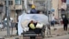 People transport their belongings as they drive through the Bureij refugee camp in the central Gaza Strip toward the northern part of the occupied Palestinian territory on Feb. 7, 2025.