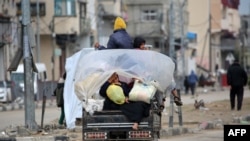 People transport their belongings as they drive through the Bureij refugee camp in the central Gaza Strip toward the northern part of the occupied Palestinian territory on Feb. 7, 2025.