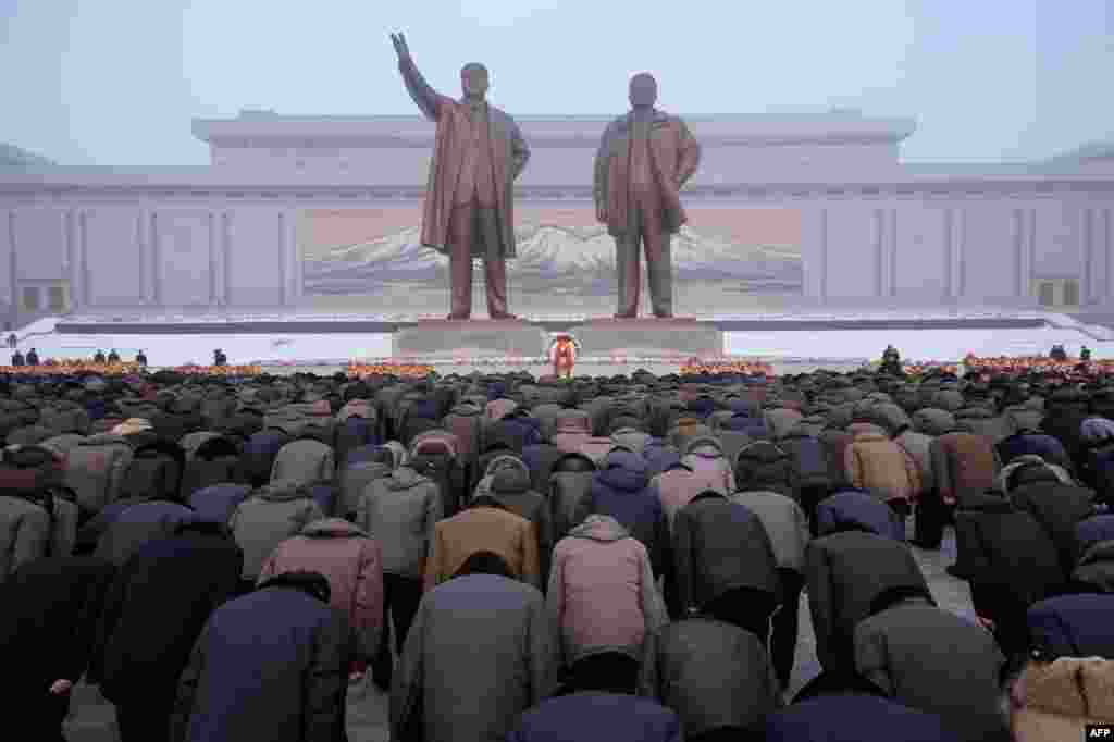 Pyongyang residents bow before the statues of late North Korean leaders Kim Il Sung and Kim Jong Il during National Memorial Day on Mansu Hill in Pyongyang.
