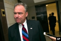 FILE - Sen. Tim Kaine, D-Va., speaks with a reporter as he arrives for a classified briefing on Capitol Hill in Washington.