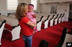 Vicky Chavez comforts her daughter Issabella in the First Unitarian Church, in Salt Lake City, Utah, May 31, 2018. Chavez says seeing fellow Central Americans separated from their children at the U.S.-Mexico border makes her intent on trying to fight to stay in the United States.