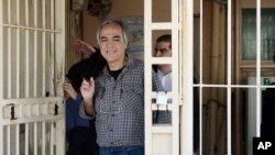 Dimitris Koufodinas, 59, smiles as he leaves Korydallos prison in western Athens, Nov. 9, 2017.