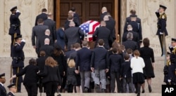 Family members follow behind the casket of the late Supreme Court Associate Justice Antonin Scalia as they arrive for a funeral Mass at the Basilica of the National Shrine of the Immaculate Conception in Washington, Feb. 20, 2016.