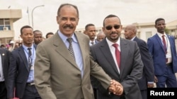 Eritrean President Isaias Afwerki and Ethiopian Prime Minister Abiy Ahmed walk together at Asmara International Airport, Eritrea, July 9, 2018. A peace deal between the East African neighbors garnered international commendations.