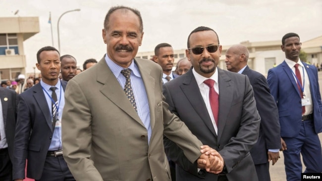 Eritrean President Isaias Afwerki and Ethiopian Prime Minister Abiy Ahmed walk together at Asmara International Airport, Eritrea, July 9, 2018. A peace deal between the East African neighbors garnered international commendations.