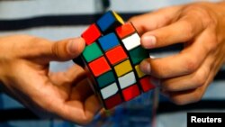 FILE - A competitor attends the World Rubik's Cube Championship in Budapest. 