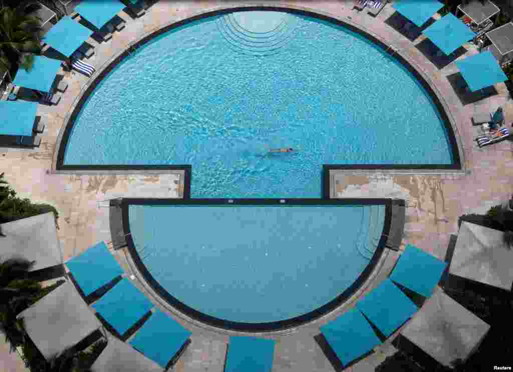 A man swims in a hotel pool at the Pan Pacific Hotel in Singapore.