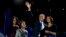 FILE - President Barack Obama waves as he walks on stage with first lady Michelle Obama and daughters Malia and Sasha at his election night party in Chicago, Nov. 7, 2012.