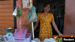 Nancy Hemalatha, 61, a fruit seller waits for customers at her shop in Thotalanga, Colombo, Sri Lanka, Sept. 9, 2024.