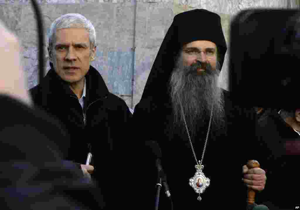 Serbia's President Boris Tadic (L) and Orthodox Bishop Teodosije address the press after Christmas liturgy at the 14th century Orthodox monastery Visoki Decani in the western Kosovo town of Decani ,January 7, 2012. Kosovo Albanian protesters hurled stones