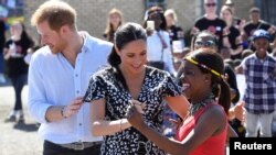 The Duke and Duchess of Sussex, Prince Harry and his wife Meghan, are seen during a Justice Desk initiative in Nyanga township, on the first day of their African tour in Cape Town, South Africa, Sept. 23, 2019.