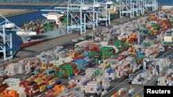 FILE - An aerial photo shows shipping containers at the ports of Los Angeles and Long Beach, California.