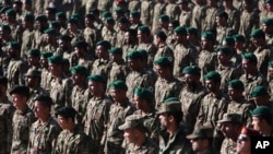 New members of the Afghan National Army attend their graduation ceremony at the Afghan Military Academy in Kabul, Afghanistan, Nov. 23, 2014. 