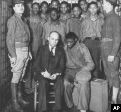Defense attorney Samuel Leibowitz meets with his clients in Scottsboro, Alabama (1933).