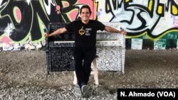 Malek Jandali, Syrian pianist and founder of the Pianos for Peace charity, poses in front of a colorful piano during the Pianos for Peace festival in Atlanta, Georgia.