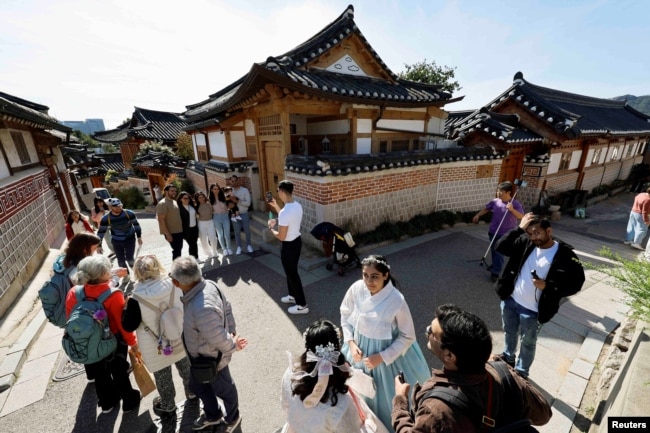 Tourists gather and interact at Bukchon Hanok Village in Seoul, South Korea, October 20, 2024. (REUTERS/Kim Soo-hyeon)