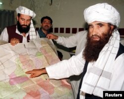 FILE - Jalaluddin Haqqani, right, founder of the Haqqani network, is seen during a visit to Islamabad, Pakistan, Oct. 19, 2001. A speech by one of his sons, Sirajuddin Haqqani, who now heads the network, is drawing renewed attention.