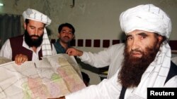 FILE - Jalaluddin Haqqani, right, founder of the Haqqani network, is seen during a visit to Islamabad, Pakistan, Oct. 19, 2001. A speech by one of his sons, Sirajuddin Haqqani, who now heads the network, is drawing renewed attention.