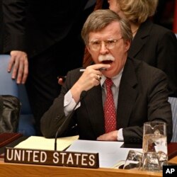 FILE - John Bolton, then the U.S. ambassador to the United Nations, listens to statements concerning the Middle East during a Security Council meeting at the U.N. headquarters in New York, Nov. 9, 2006.