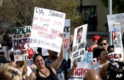Protesters march down a street after the funeral for police shooting victim Stephon Clark, in Sacramento, California, March 29, 2018.