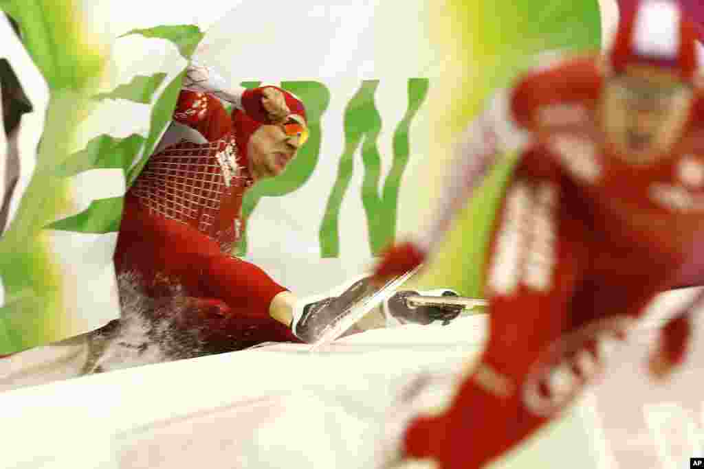 Poland's Piotr Puszkarski, left, crashes while competing with Poland's Jan Szymanski in the men's 500-meter race during the World Championship allround speedskating at Thialf skating arena in Heerenveen, northern Netherlands.