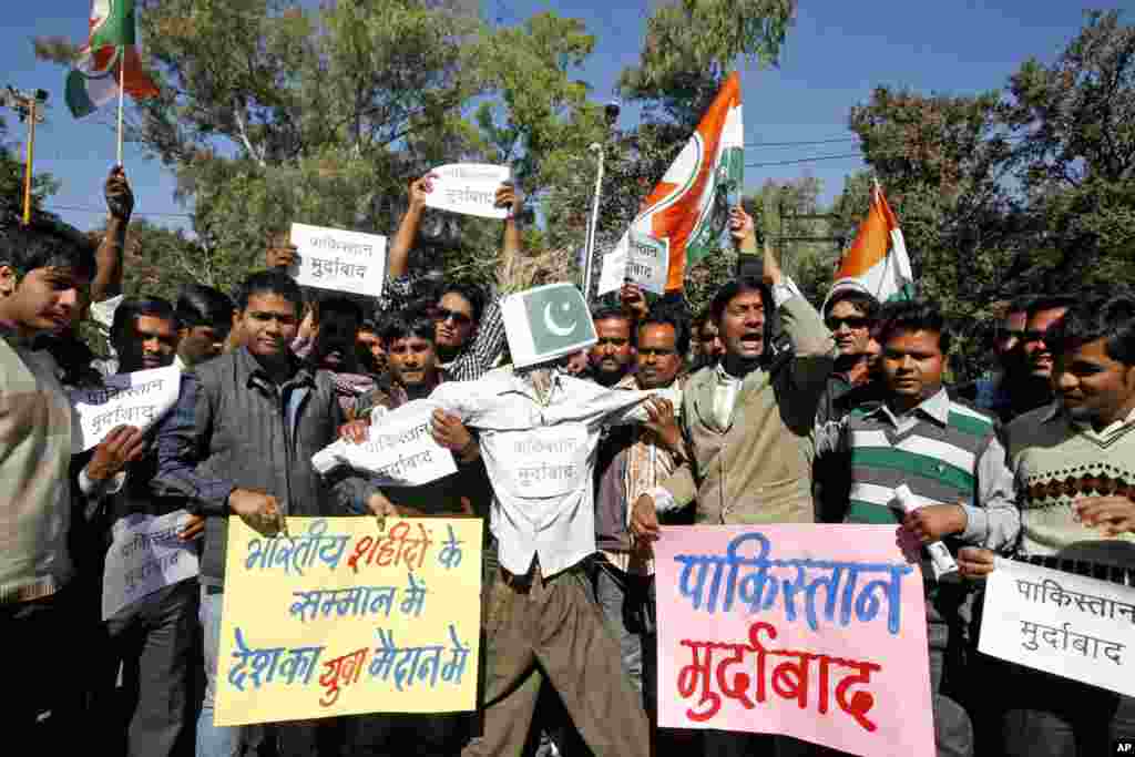 Congress party activists shout slogans before burning an effigy representing Pakistan during a protest in Bhopal, India, January 9, 2013.