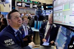 Specialist Frank Masiello, left, works at his post on the floor of the New York Stock Exchange, Nov. 7, 2016.