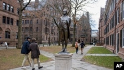 FILE - A statue of Nathan Hale, a Yale University class of 1773 graduate, with his hands and ankles bound with rope and the inscription "I only regret that I have but one life to lose for my country" is in front of Hale's former dormitory Connecticut Hall on Dec. 4, 2023. 