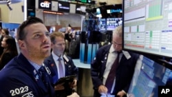 Specialist Frank Masiello, left, works at his post on the floor of the New York Stock Exchange, Monday, Nov. 7, 2016. Stocks are opening sharply higher on Wall Street after the F.B.I. said newly discovered emails didn't warrant any action against Hillary Clinton.