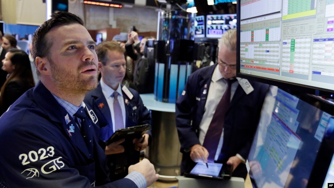 Specialist Frank Masiello, left, works at his post on the floor of the New York Stock Exchange, Nov. 7, 2016. Stocks opened sharply higher on Wall Street after the FBI said newly discovered emails didn't warrant any action against presidential candidate Hillary Clinton. 