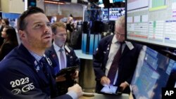 Specialist Frank Masiello, left, works at his post on the floor of the New York Stock Exchange, Nov. 7, 2016. Stocks opened sharply higher on Wall Street after the FBI said newly discovered emails didn't warrant any action against presidential candidate Hillary Clinton. 