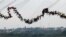 People jump off a bridge, which has a height of 30 meters, in Hortolandia, Brazil, Oct. 22, 2017. According to organizers, 245 people were attempting set a new world record for "rope jumping", in which people, tied to a safety cord, jump off a bridge.
