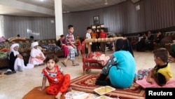 Displaced members of the Yazidi sect, fleeing Islamic State militants, take refuge in Dohuk province, Iraq, Aug. 7, 2014.